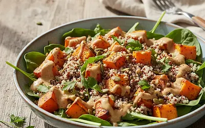 Hearty salad with roasted sweet potato, quinoa, and tahini dressing